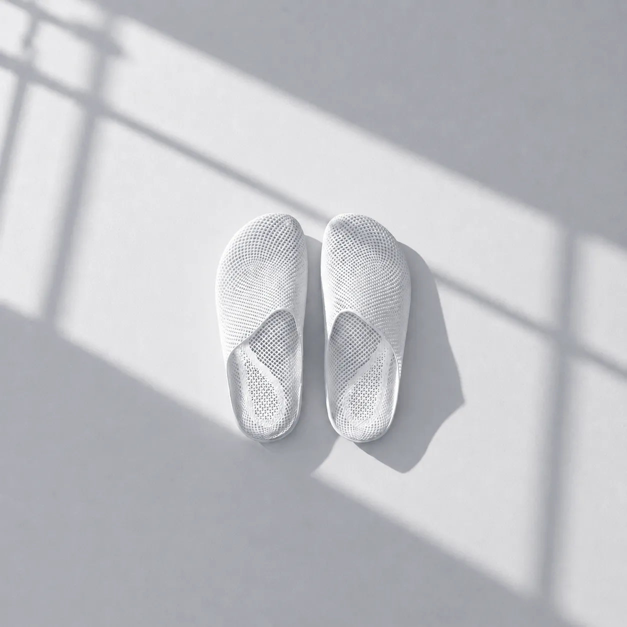 EASE 01 3D printed house slipper —  showing fine mesh lattice upper and minimal sole