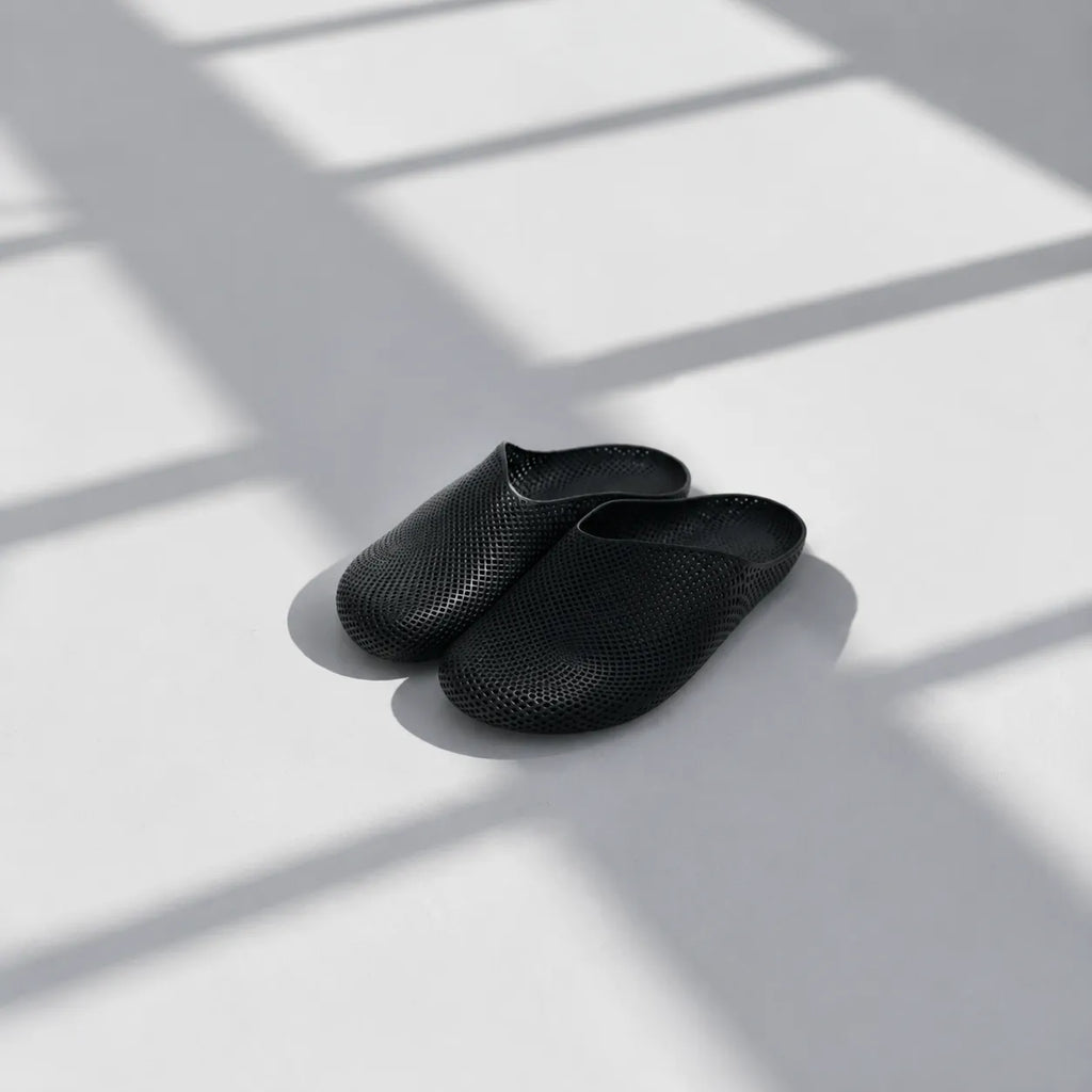 EASE 01 3D printed house slipper —  showing fine mesh lattice upper and minimal sole