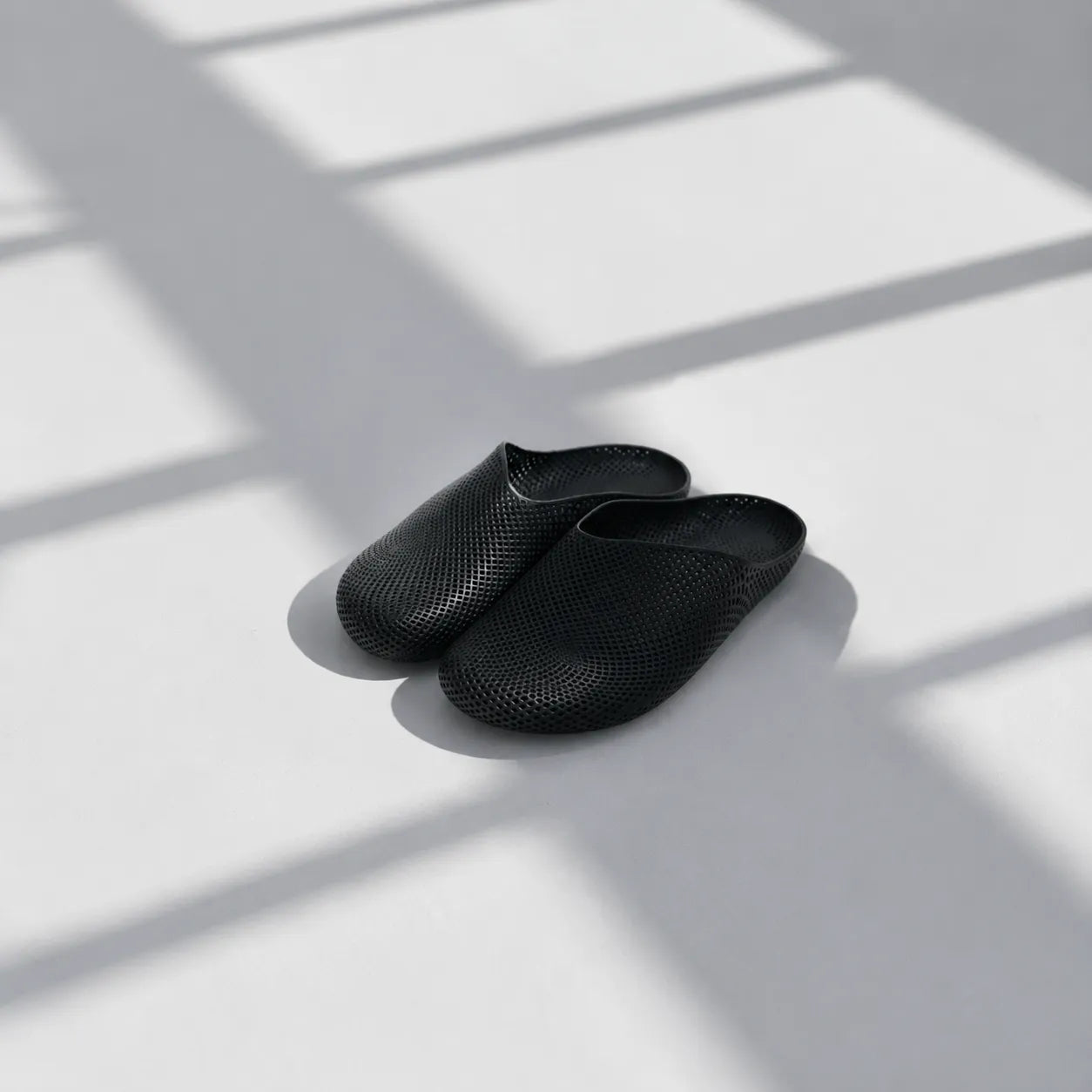 EASE 01 3D printed house slipper —  showing fine mesh lattice upper and minimal sole