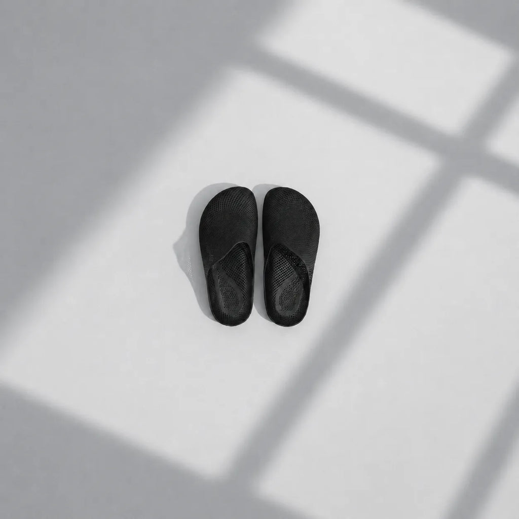 EASE 01 3D printed house slipper —  showing fine mesh lattice upper and minimal sole