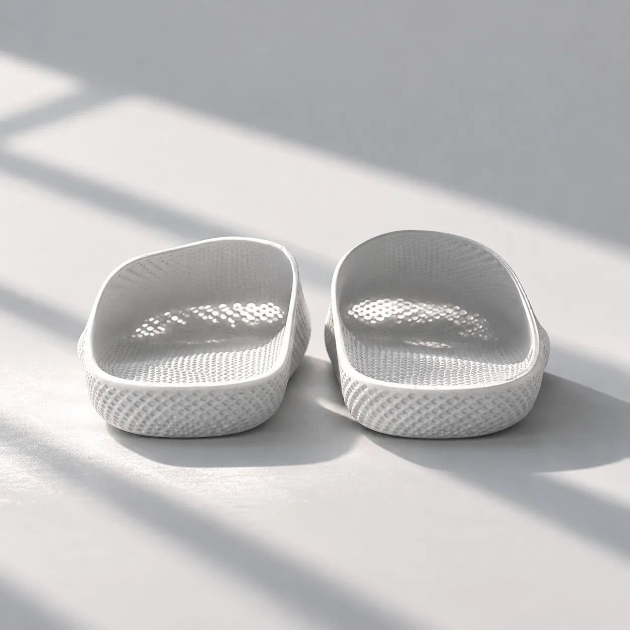 EASE 01 3D printed house slipper —  showing fine mesh lattice upper and minimal sole