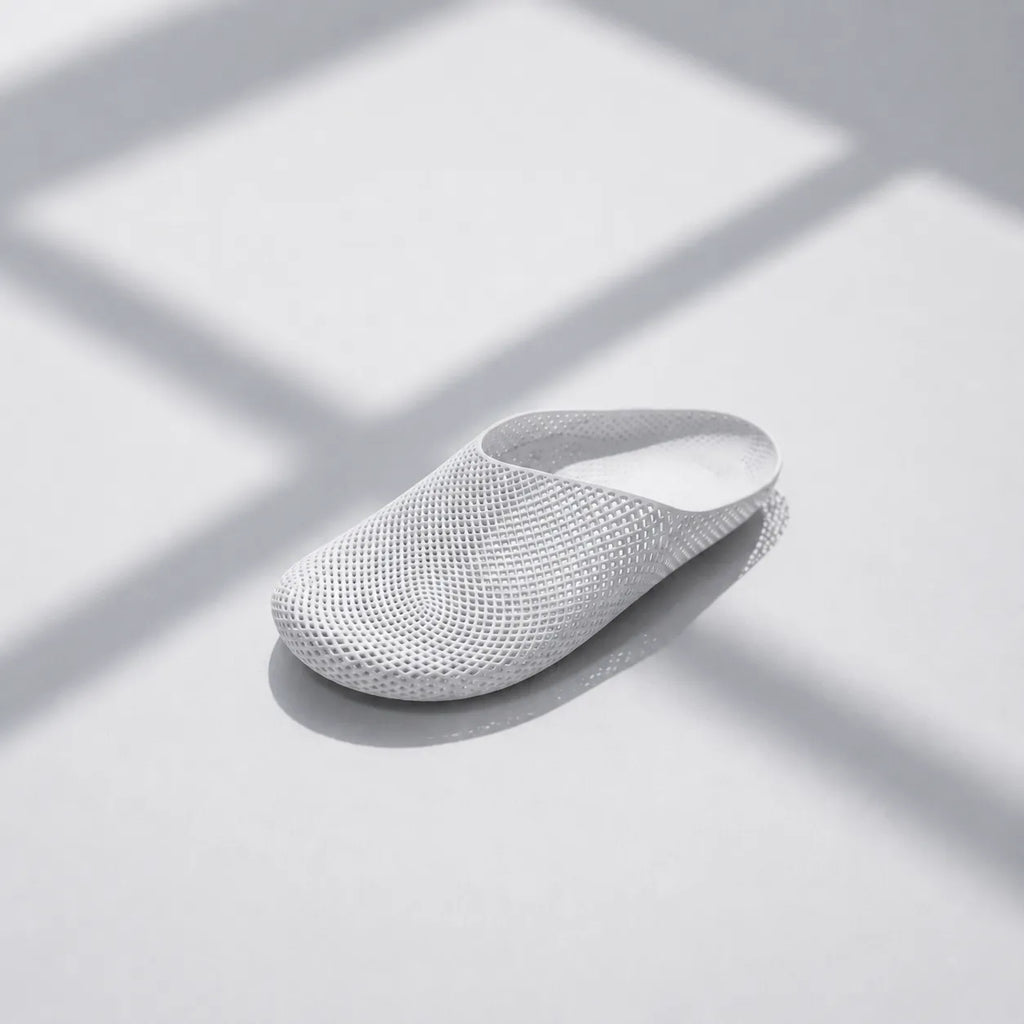 EASE 01 3D printed house slipper —  showing fine mesh lattice upper and minimal sole