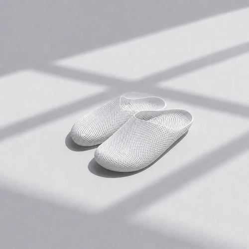 EASE 01 3D printed house slipper —  showing fine mesh lattice upper and minimal sole