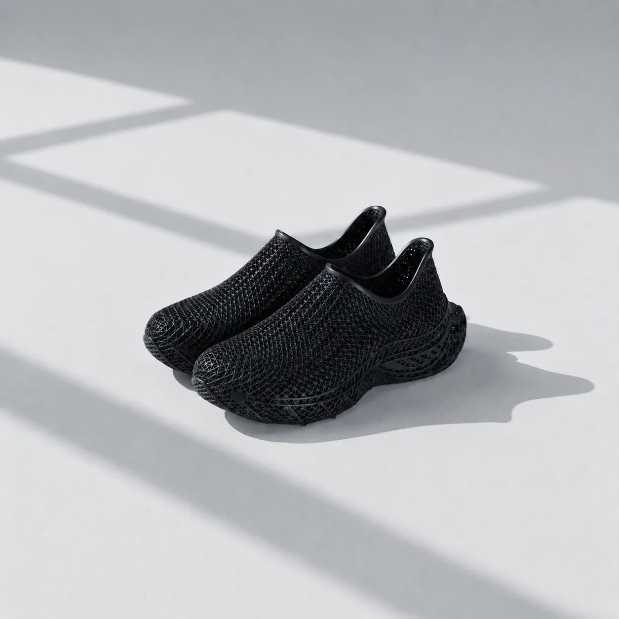 EXTRALOGIA FORM02 3D printed shoe pair — showing triangulated open-lattice structure