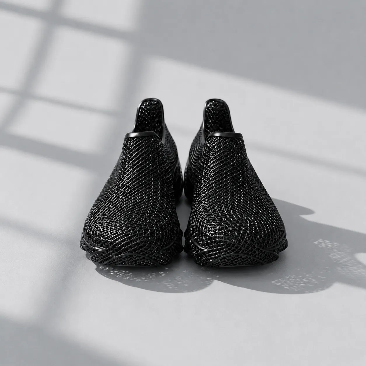 EXTRALOGIA FORM02 3D printed shoe pair — showing triangulated open-lattice structure