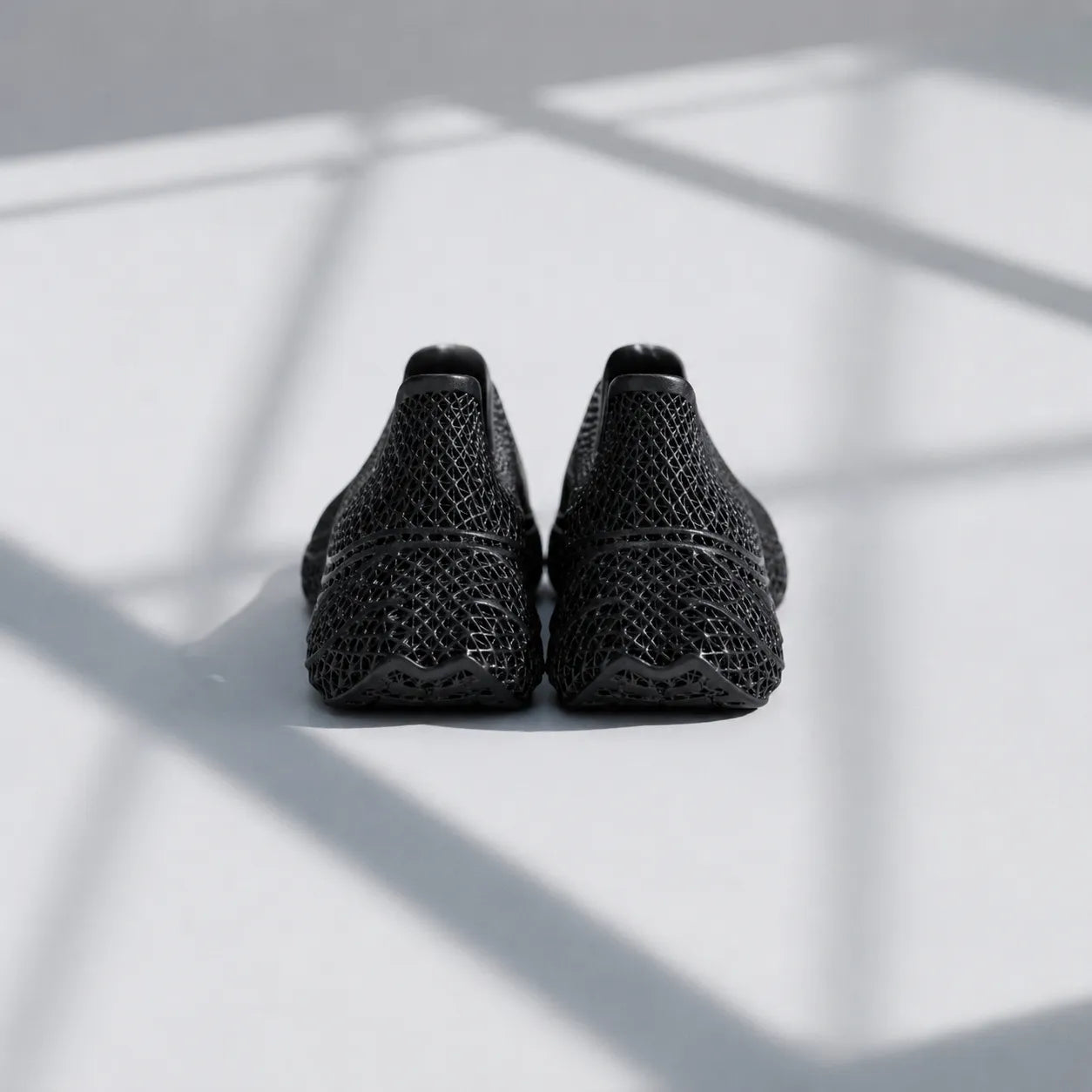 EXTRALOGIA FORM02 3D printed shoe pair — showing triangulated open-lattice structure