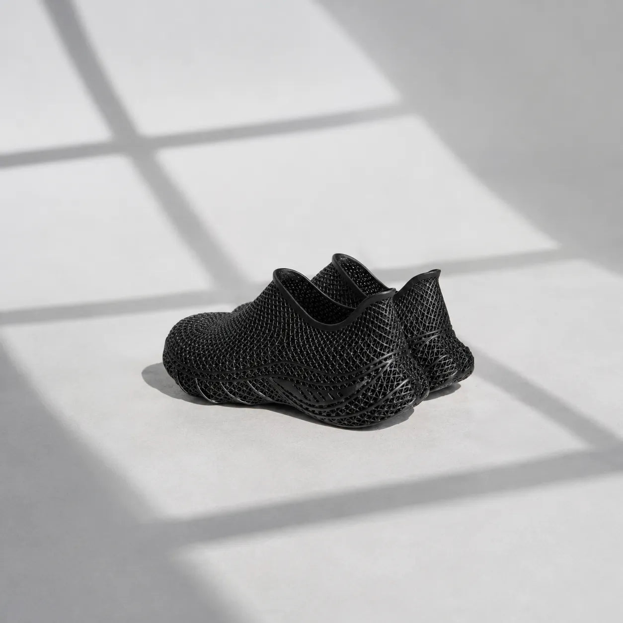 EXTRALOGIA FORM02 3D printed shoe pair — showing triangulated open-lattice structure