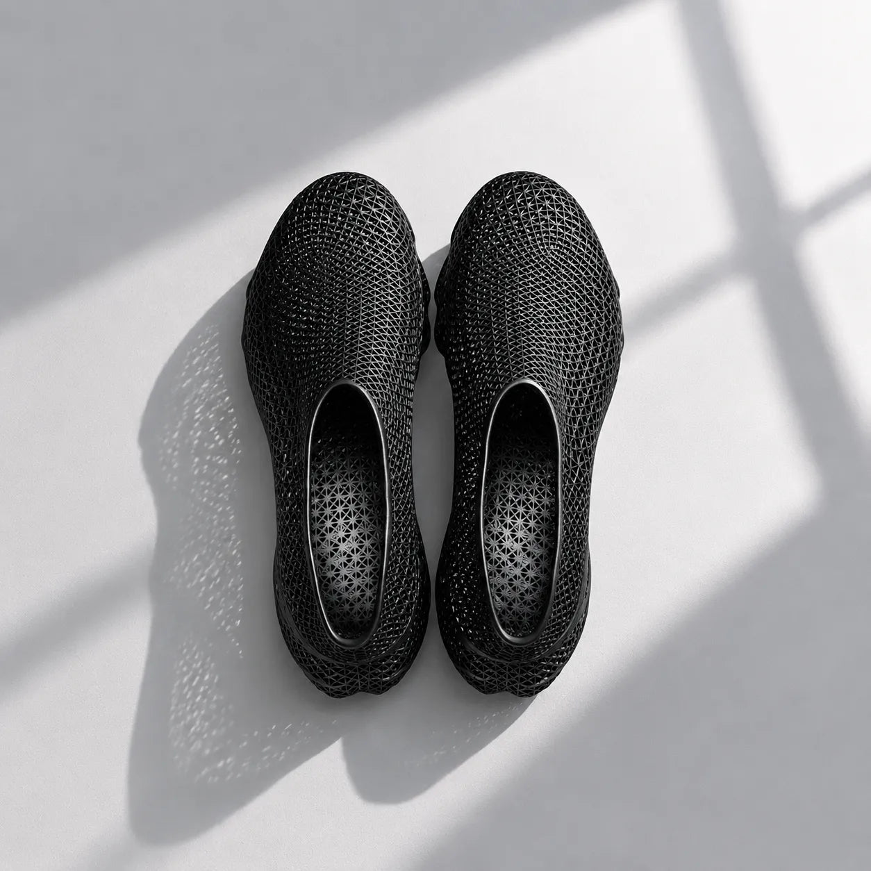 EXTRALOGIA FORM02 3D printed shoe pair — showing triangulated open-lattice structure